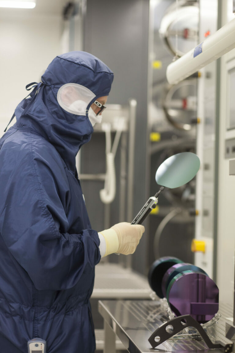 Researcher in teh cean room working on vapor cells fabrication